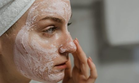 women applying skin cream