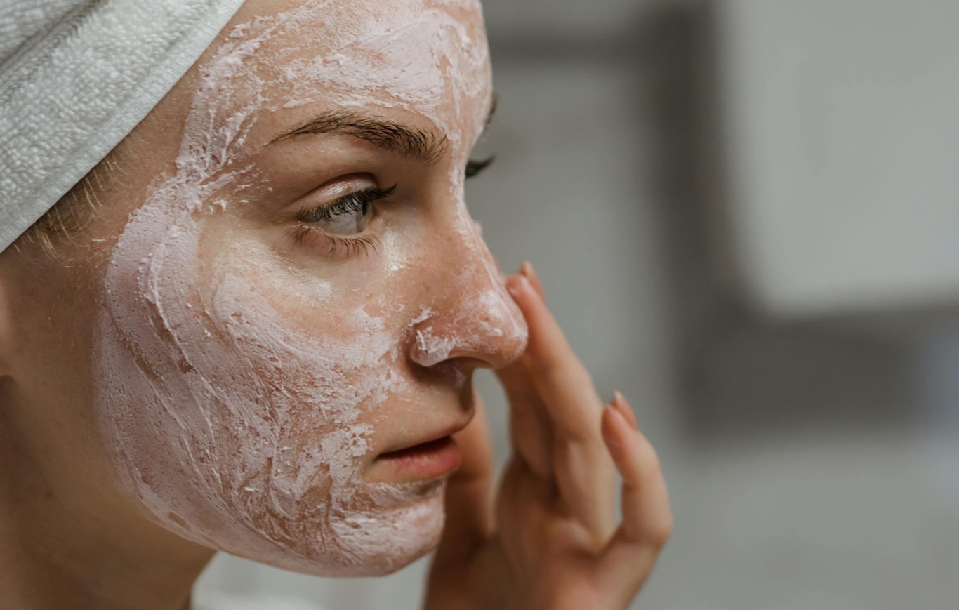 women applying skin cream