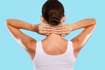 Back,View,Of,Unrecognizable,Woman,Touching,And,Massaging,Her,Neck