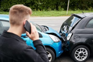Young,Male,Motorist,Involved,In,Car,Accident,Calling,Insurance,Company