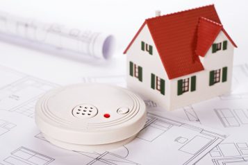 Smoke,Detector,With,House,And,Blueprints