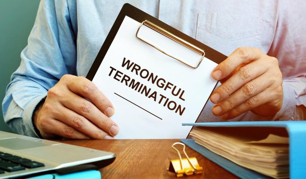 employee holds papers about wrongful termination