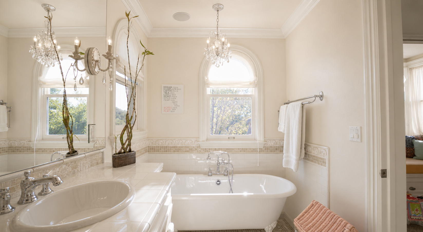 Primary bathroom with layered lighting and daylight from arched windows