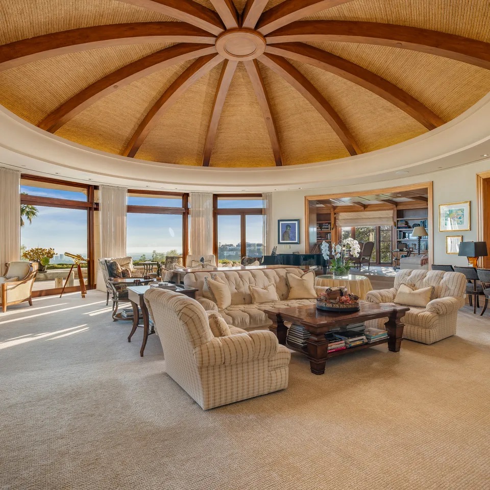 Domed living room with panoramic windows and layered natural light