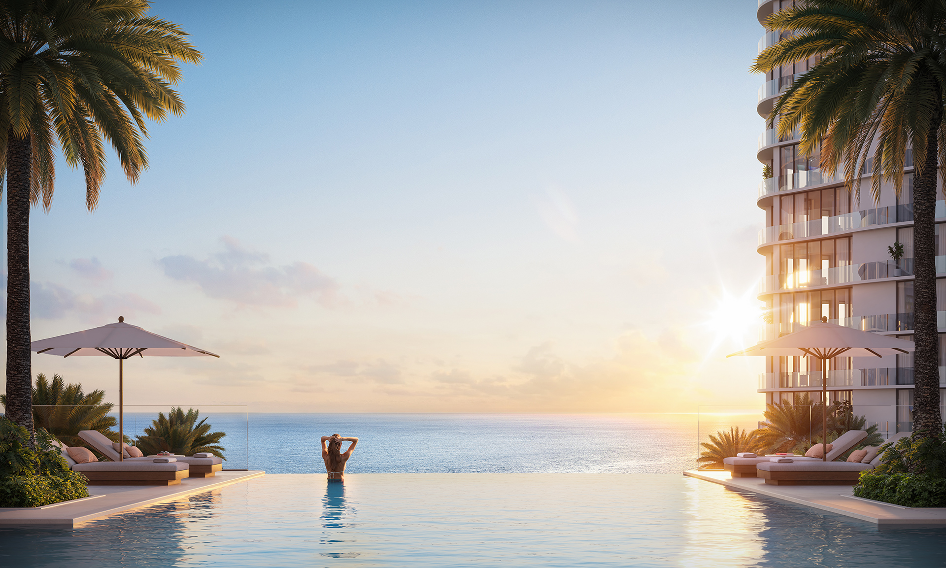 Oceanfront branded residence infinity pool at sunset