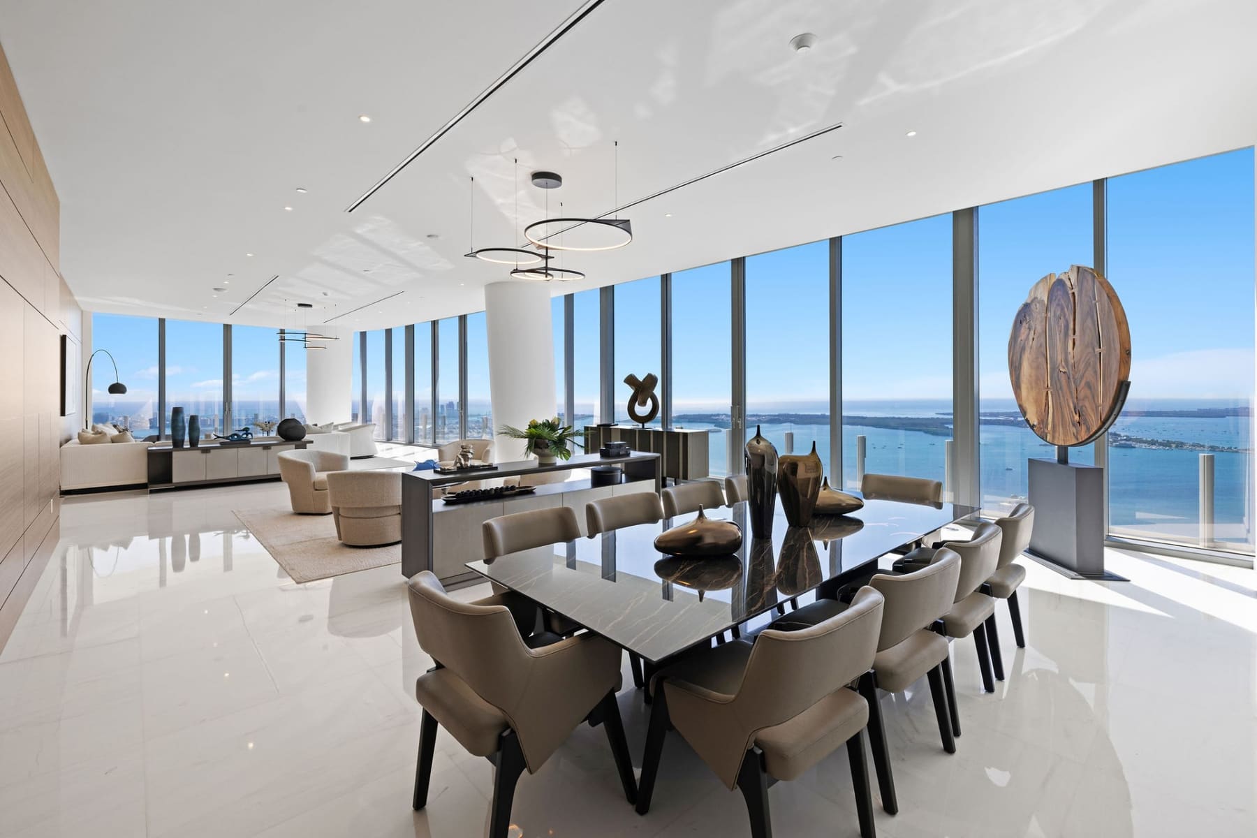 Aston Martin Residences Penthouse dining and living area with panoramic bay views