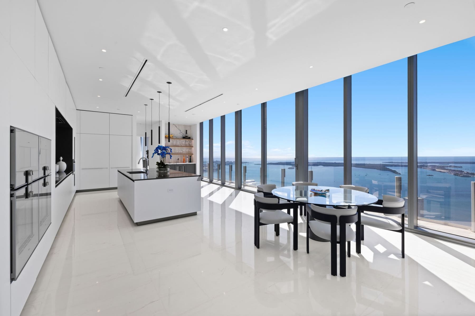 Custom gourmet kitchen with floor-to-ceiling windows and ocean views