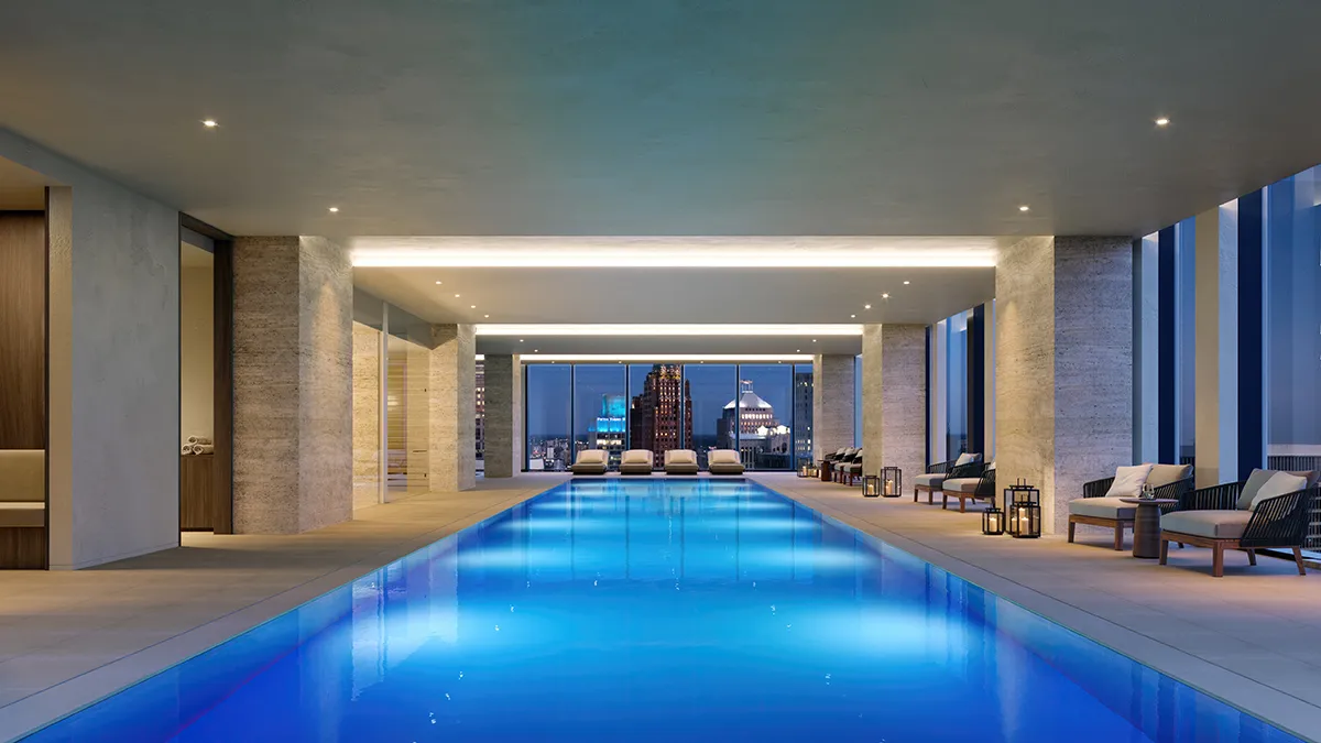 Detroit Edition indoor pool with dramatic city views at dusk
