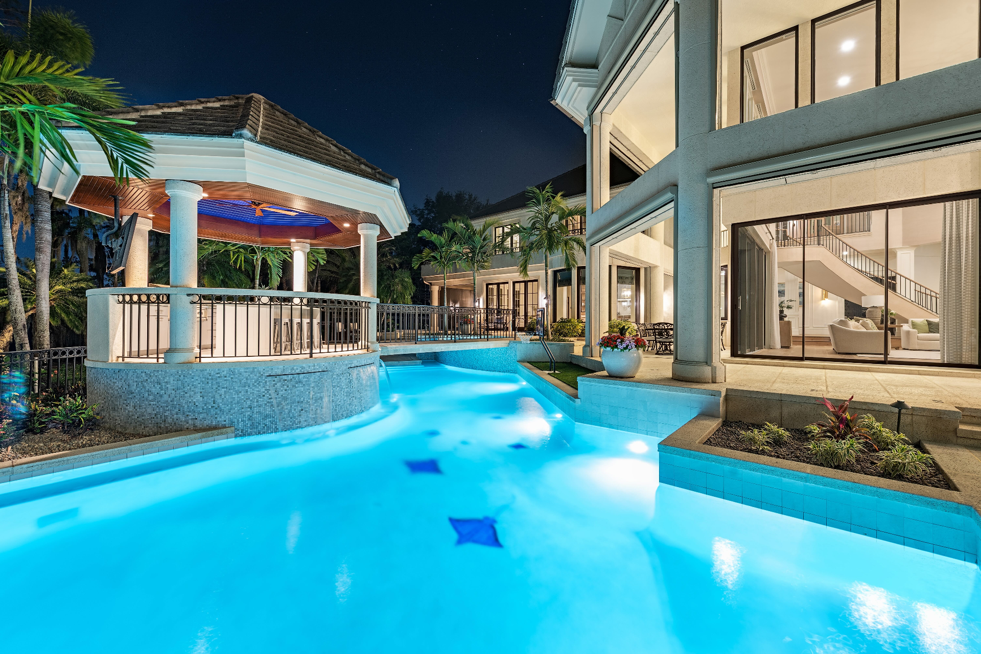 Resort-style pool and outdoor entertaining space at 4300 Brynwood Drive at night