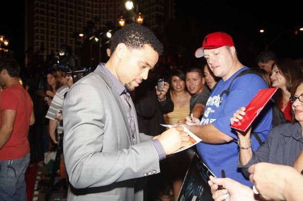 Michael Ealy autograhing for fans at red carpet