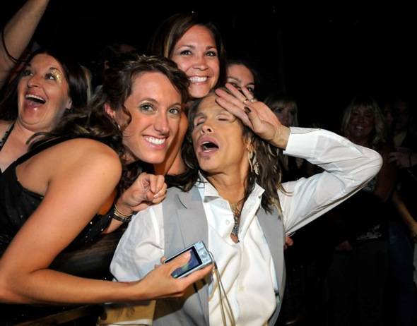 Steven Tyler poses with fans