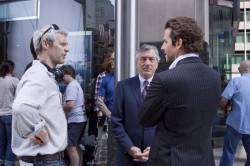 Director Neil Burger reviews a scene with star Robert De Niro and Bradley Cooper on the set of Relativity Media's LIMITLESS