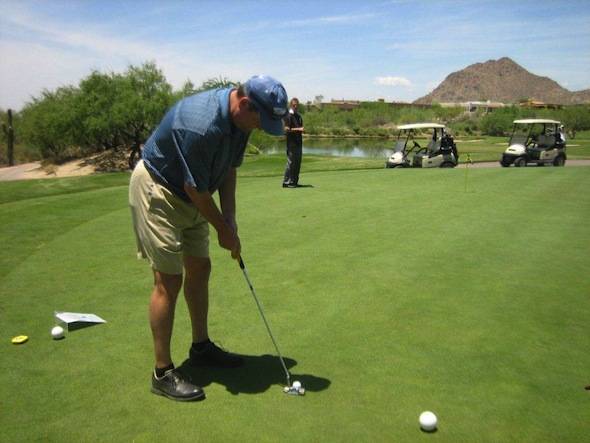 Incoming Chairman of the Board, Rick Baker attempts the putting contest
