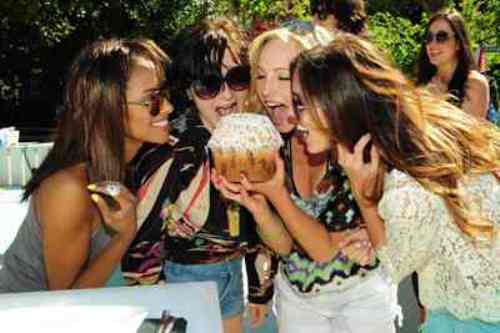 Kat Graham with giant Crumbs cupcake