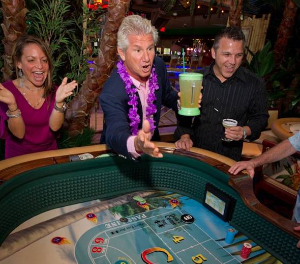 John Cohlan of Margaritaville Holdings rolls the first dice at Margaritaville Casino at the Flamingo