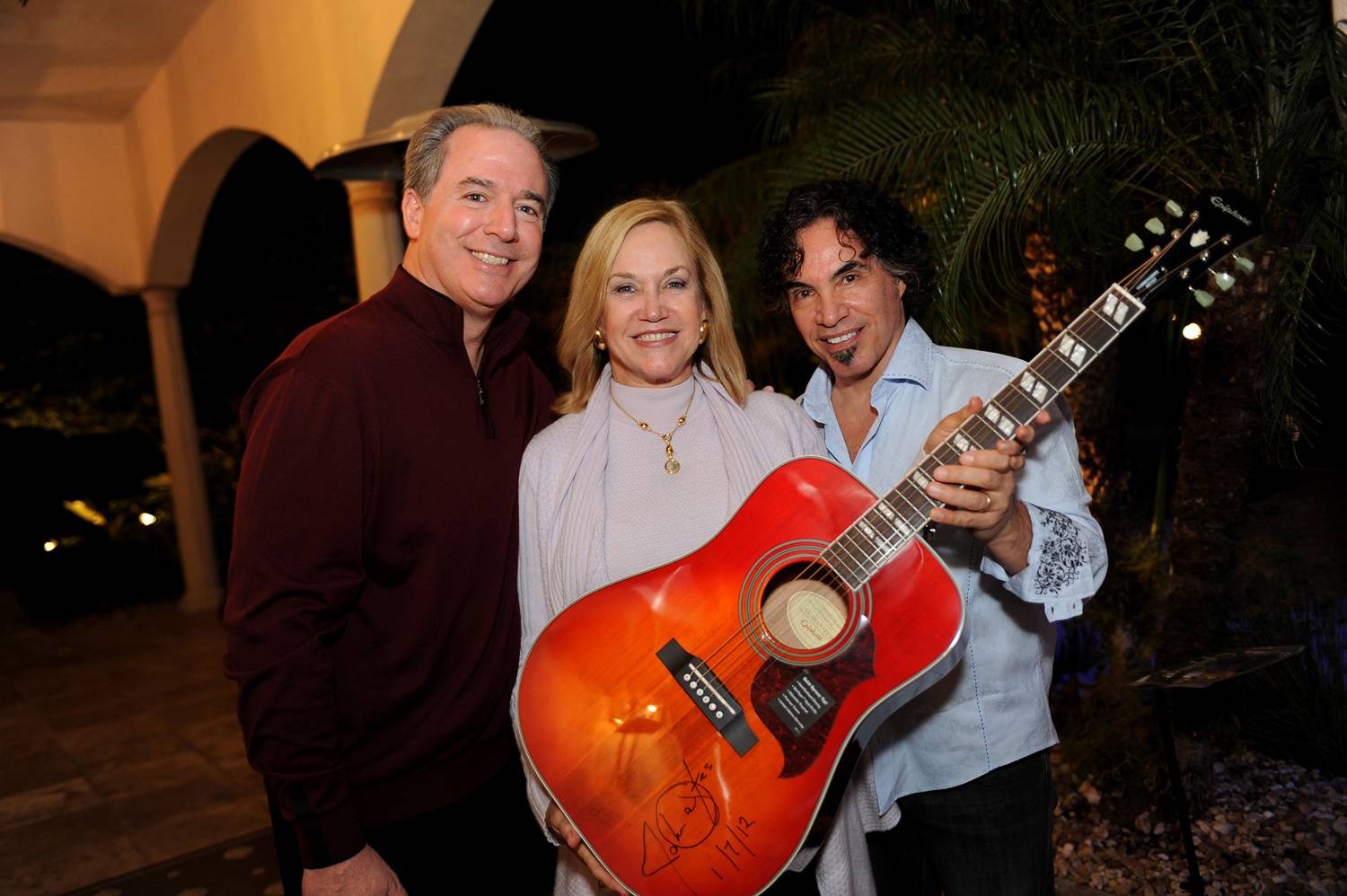 P4- Mike Maroone, Chief Operating Officer of AutoNation, Inc. and his wife Monica Maroone, with John Oates and signed guitar