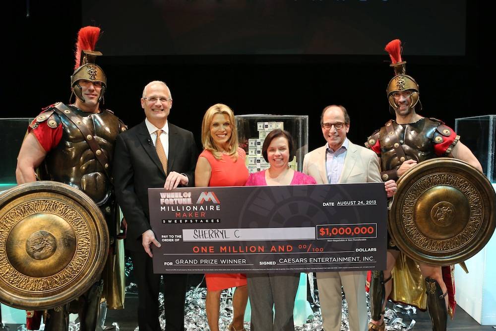 Accompanied by Caesars centurions, (left to right) Gary Selesner, Vanna White and Harry Friedman present Sherryl C with a $1 Million check