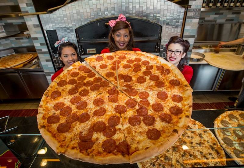 Photo2- It takes three Pin-Up Pizza girls to hold up a 30 inch pepperoni...