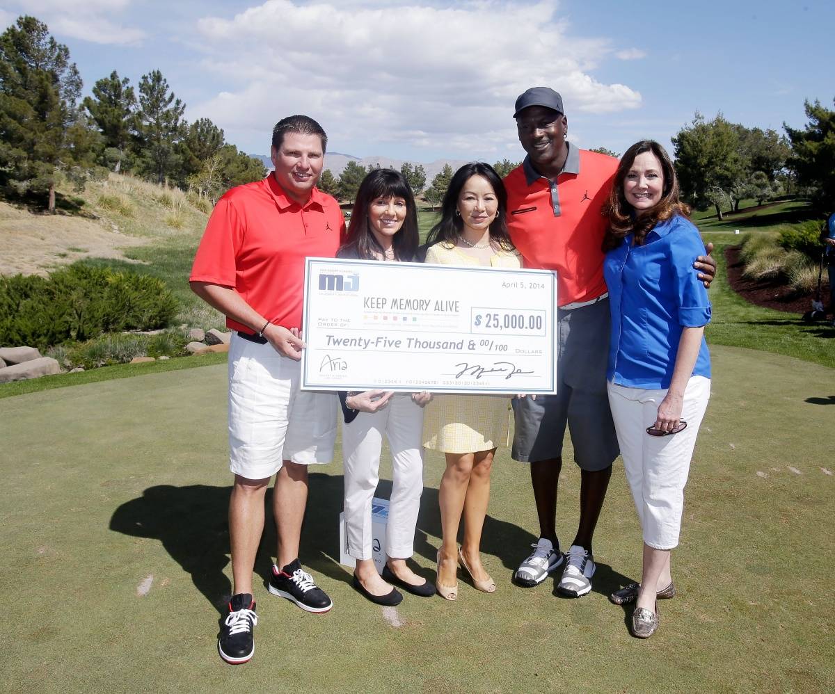 Executive Vice President MGM Resorts International Tyler Shook, (L) Dawn Russi, Kate Zhong, NBA legend Michael Jordan and Gina Hines present a check to Keep Memory Alive