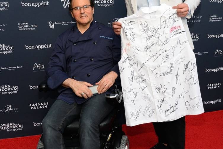 Kerry Simon and Bon Appetit Editor in Chief Adam Rapoport with signed chef's coat that will be auctioned off to benefit Keep Memory Alive (credit Ethan Miller for Bon Appetit)