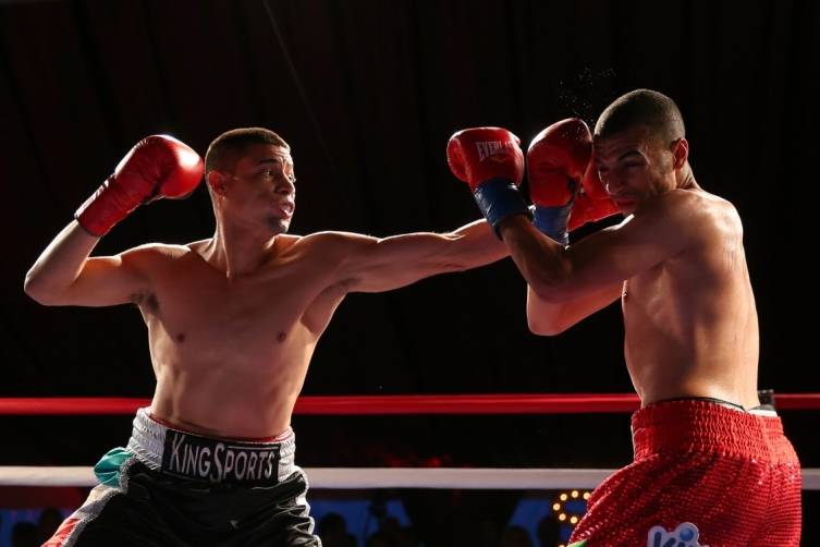 Luis Grajeda (L) fights Said el Harrak in a junior middleweight bout