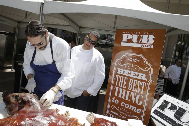 Michael Mina watches over meat preparation at the Pig Roast and Beer Garden at MGM Grand (credit Isaac Brekken for Bon Appetit)