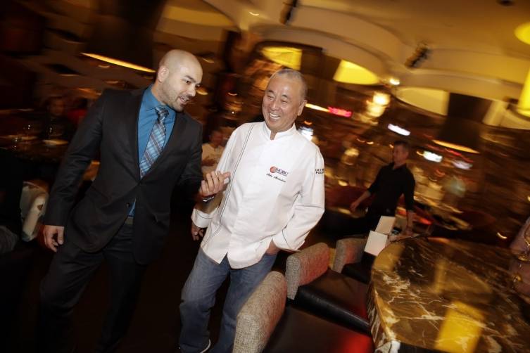 Nobu Matsuhisa laughs with a guest at Global Gourmand Master Series Dinner (credit Isaac Brekken for Bon Appetit)