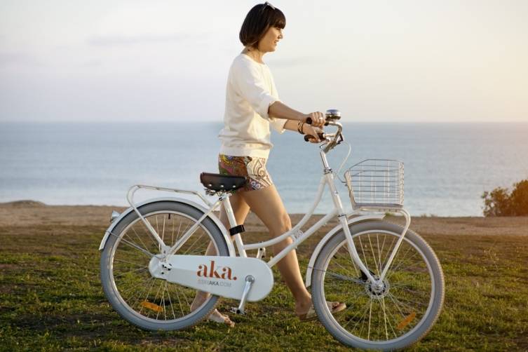 Trina Turk in Delano Short and Solvang Top with AKA's Sleek Custom Bicycles That Are Complimentary to AKA Residents