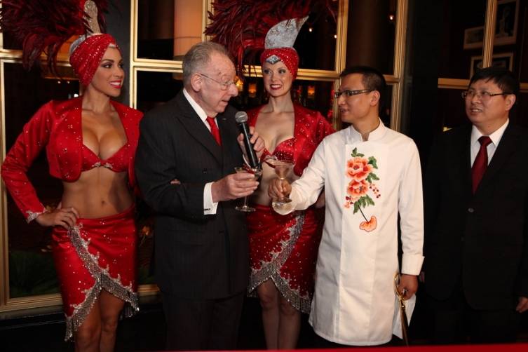 Oscar Goodman and Chef Tony Hu toast with Saphire Bombay Gin cocktail garnished with a szechuan pepper