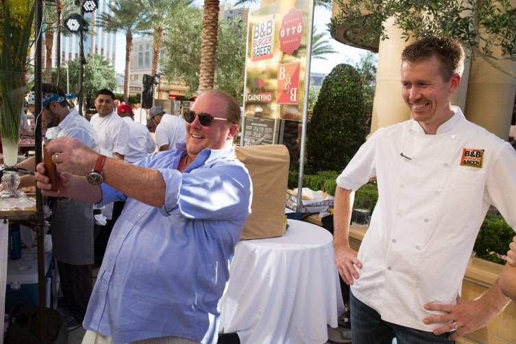 Chef Mario Batali takes a selfie with Chef Jason Neve at Carnival of Cuisine at The Palazzo