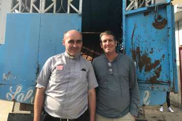 Michael Capponi with Father David Fontaine in Haiti