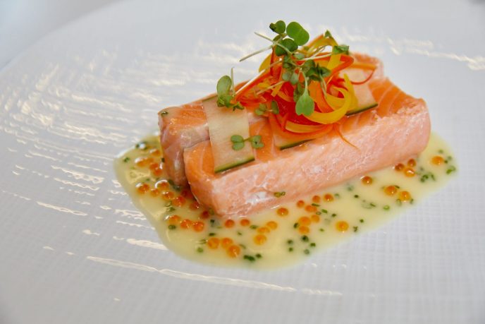 The half-smoked salmon, served with wasabi beurre blanc, bell peppers, and roe from ONE65 Bistro & Grill.