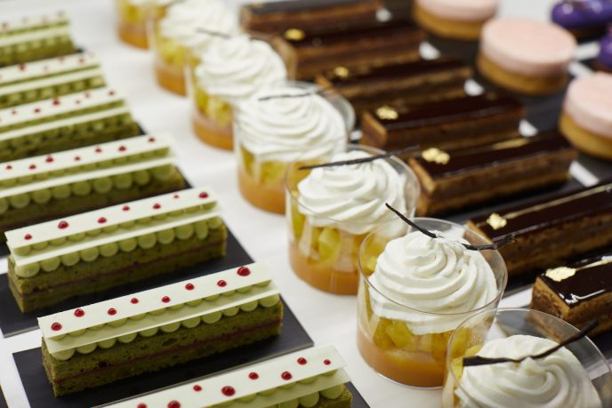 Matcha cake, rhum baba with passionfruit and vanilla whipped cream, and opera cake are featured in the pastry counter of ONE65 Patisserie & Boutique.