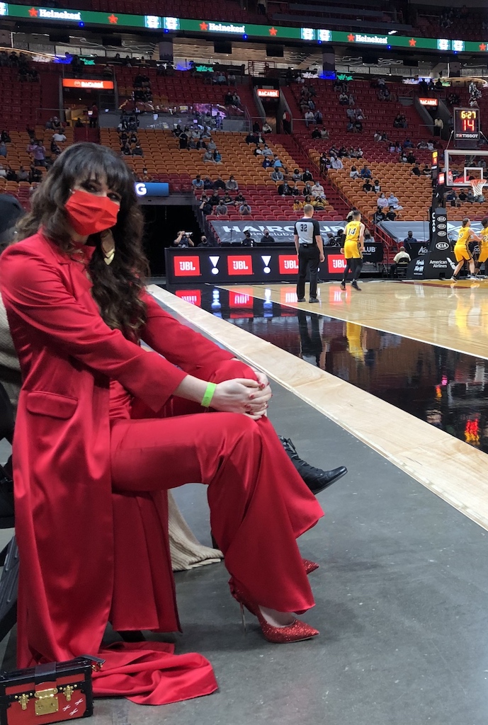 Who is the woman sitting courtside with Heat dress? How opera