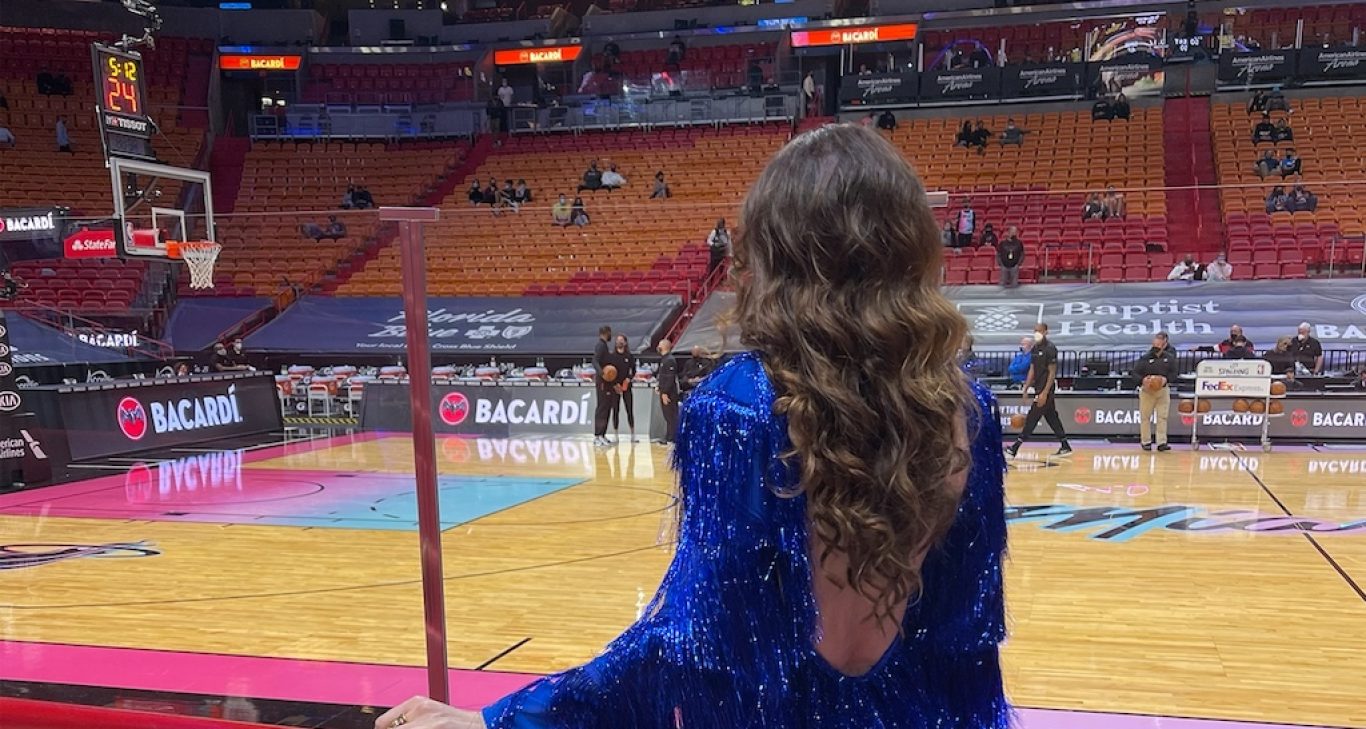 Who is the woman sitting courtside with Heat dress? How opera