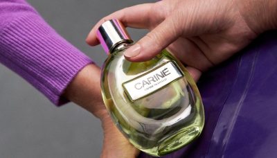 Carine Roitfeld holding perfume bottle
