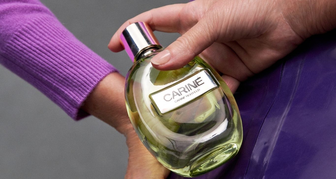 Carine Roitfeld holding perfume bottle