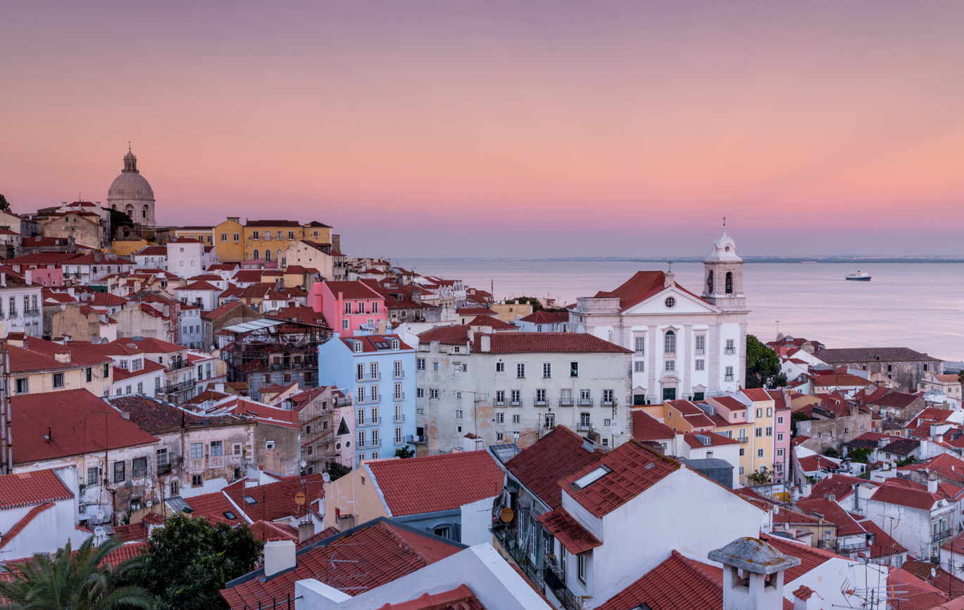 Beautiful vintage city of Lisbon with river, bridge and colorful sunset  evening sky with stars. Amazing starry sky. Space wallpaper Stock Photo