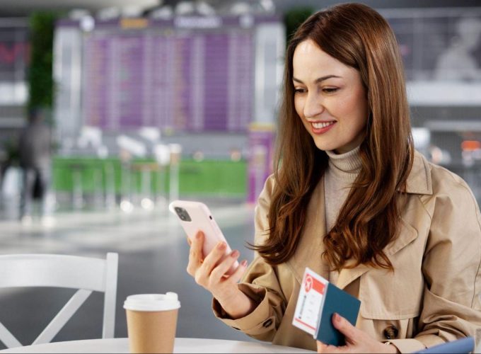 female traveller with passoprt and ticket - buying travel insurance early