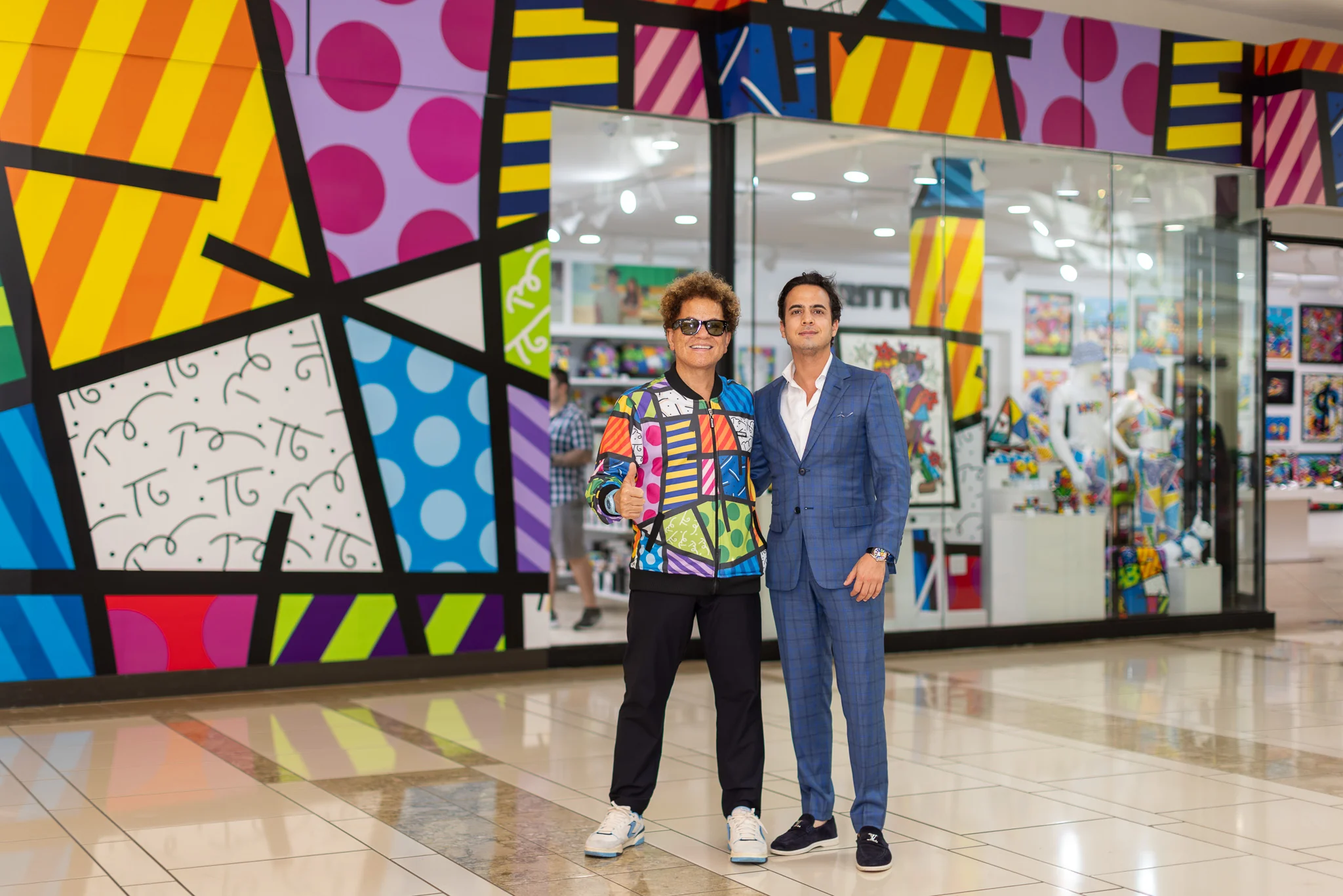 Romero Britto with Dr. Lucas Vidal, CEO of Romero Britto and Britto Group, at a gallery installation