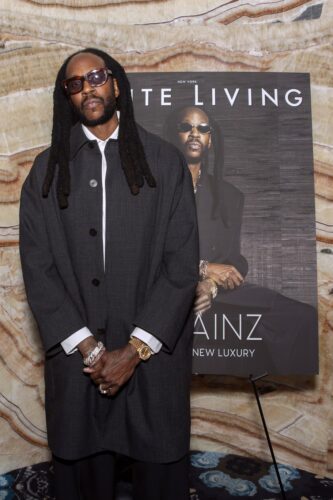 2 Chainz standing beside his Haute Living magazine cover board at Verde New York