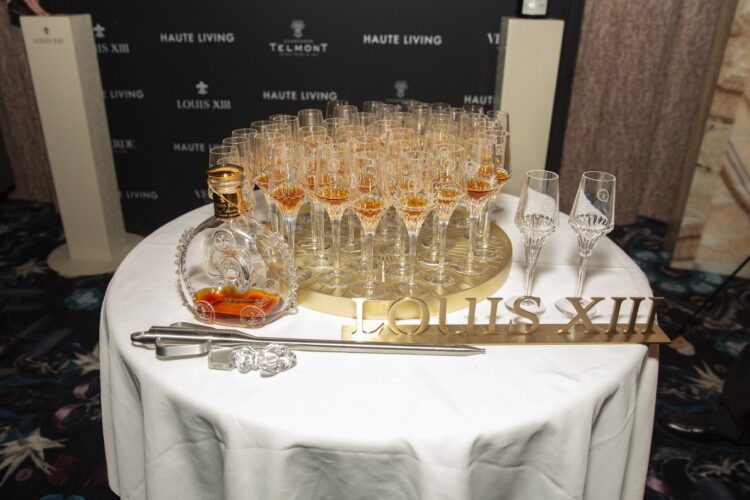 Glasses and a Louis XIII decanter on a round table at Verde New York