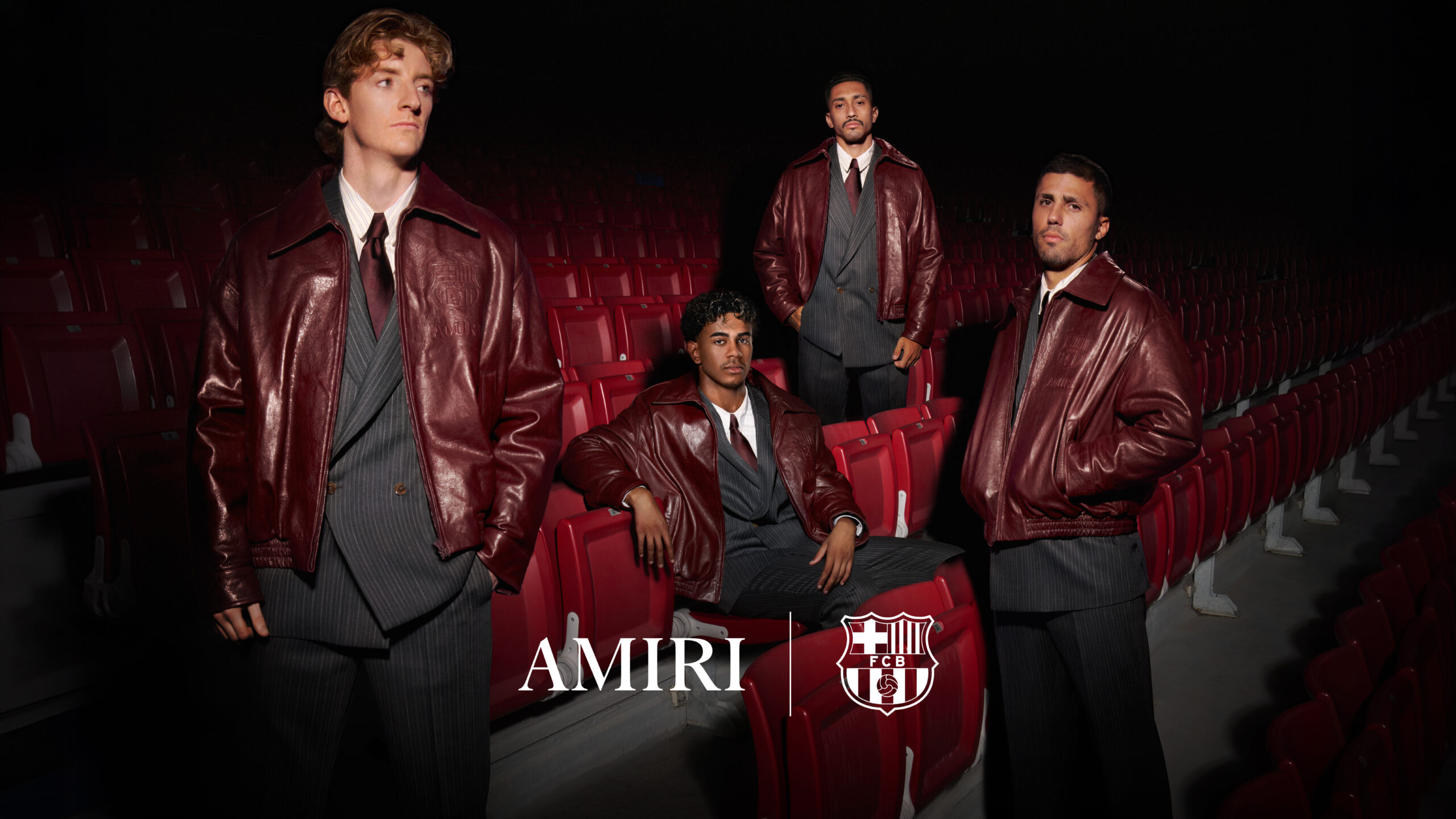 FC Barcelona players in AMIRI FC Barcelona Season Two formalwear, garnet leather blousons over grey striped suits, in the stadium stands