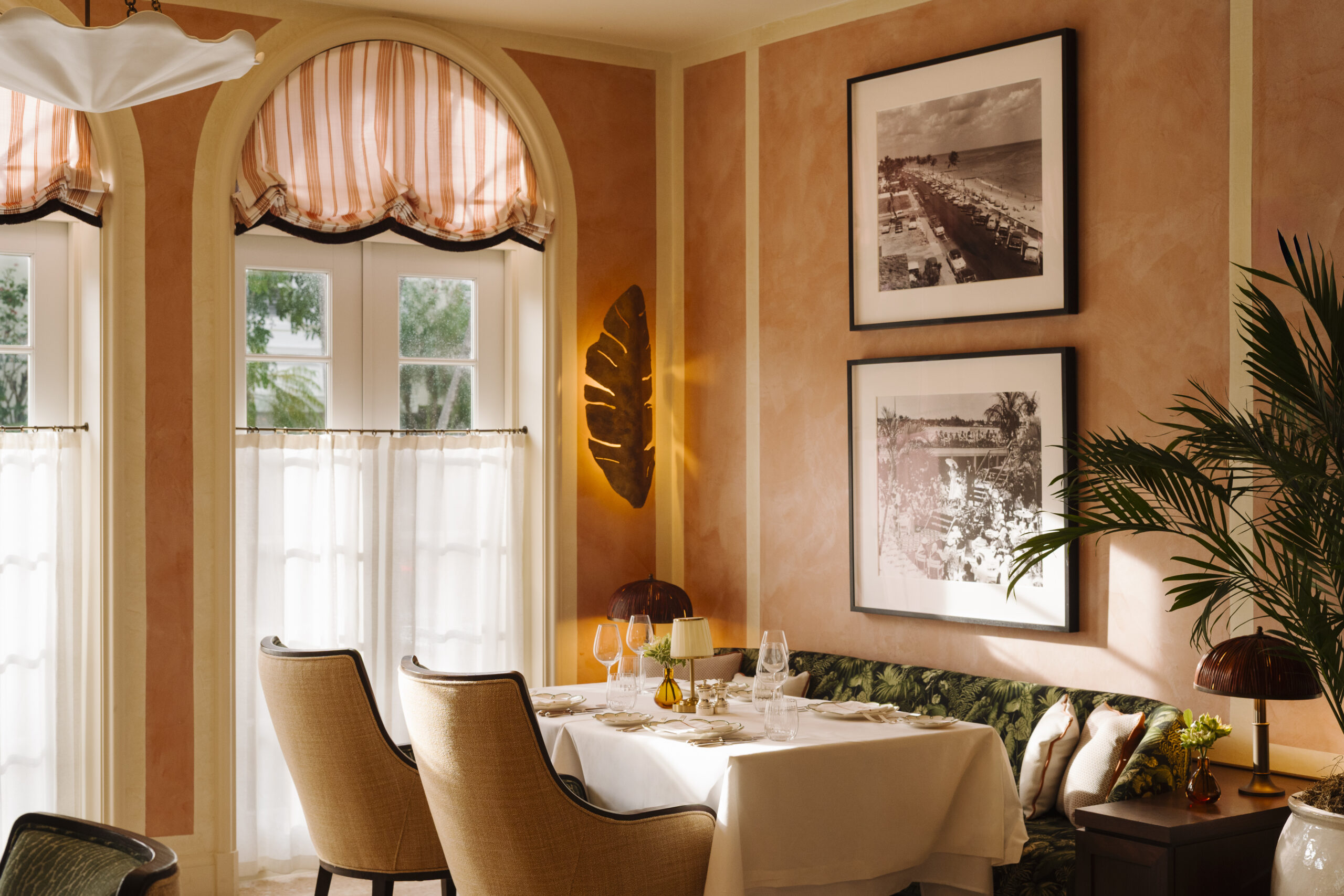 Terracotta dining room with arched windows at Coco’s in The Vineta Hotel, a new date night restaurant in Palm Beach