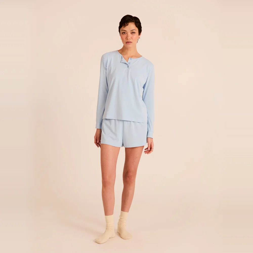 Model wearing the Arid Blayne Henley Shirt cooling sleep top in Frost pale blue with matching shorts