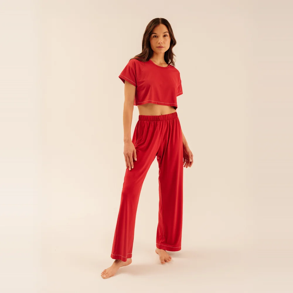 Model wearing the Arid Blayne Lasso Pant cooling pajama pant in Arid Red with a matching crop tee