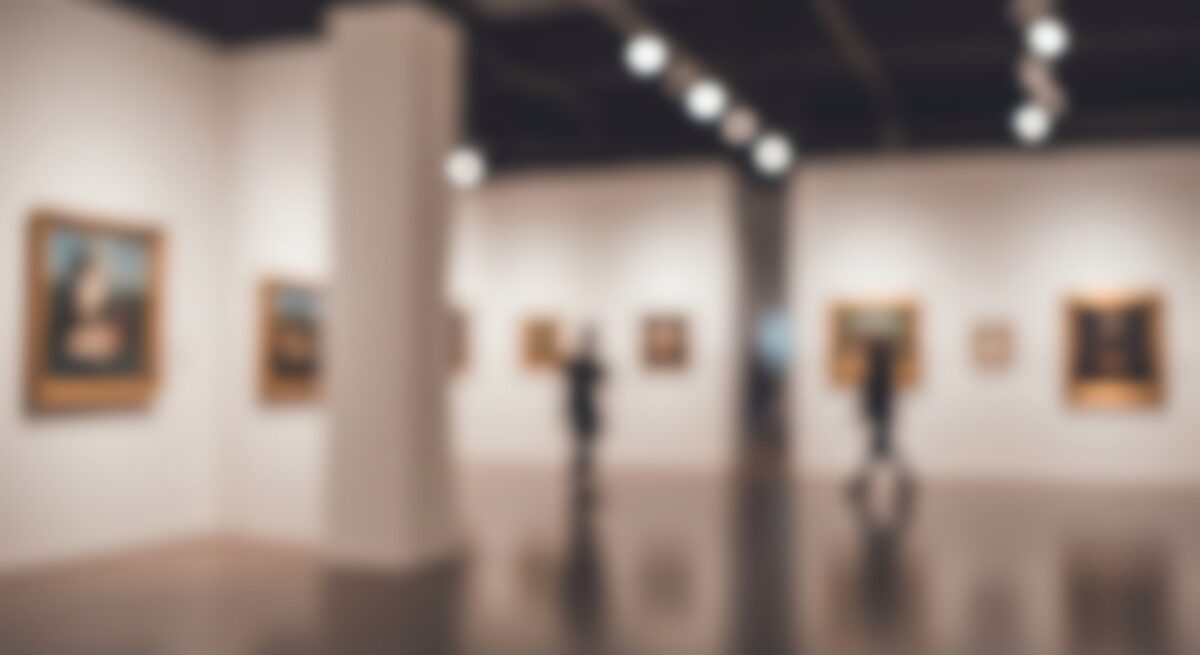 Visitors walking through an art gallery, evoking Art Basel Miami Beach 2026