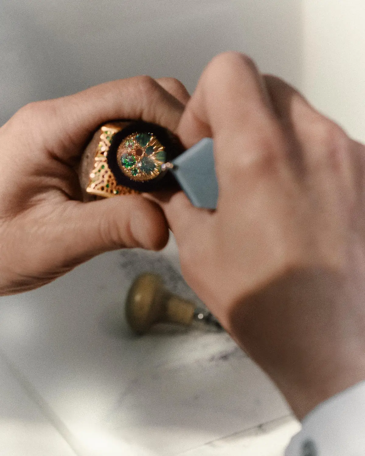 An Audemars Piguet artisan sets gemstones on a Royal Oak Joaillerie high jewelry cuff