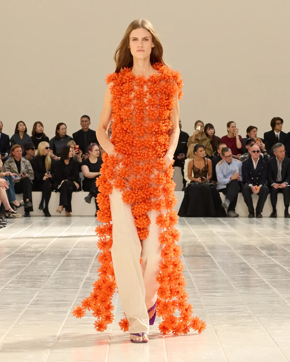 Balenciaga Summer 2027 Look 21, orange organza flowers over cream trousers, at Paris Fashion Week