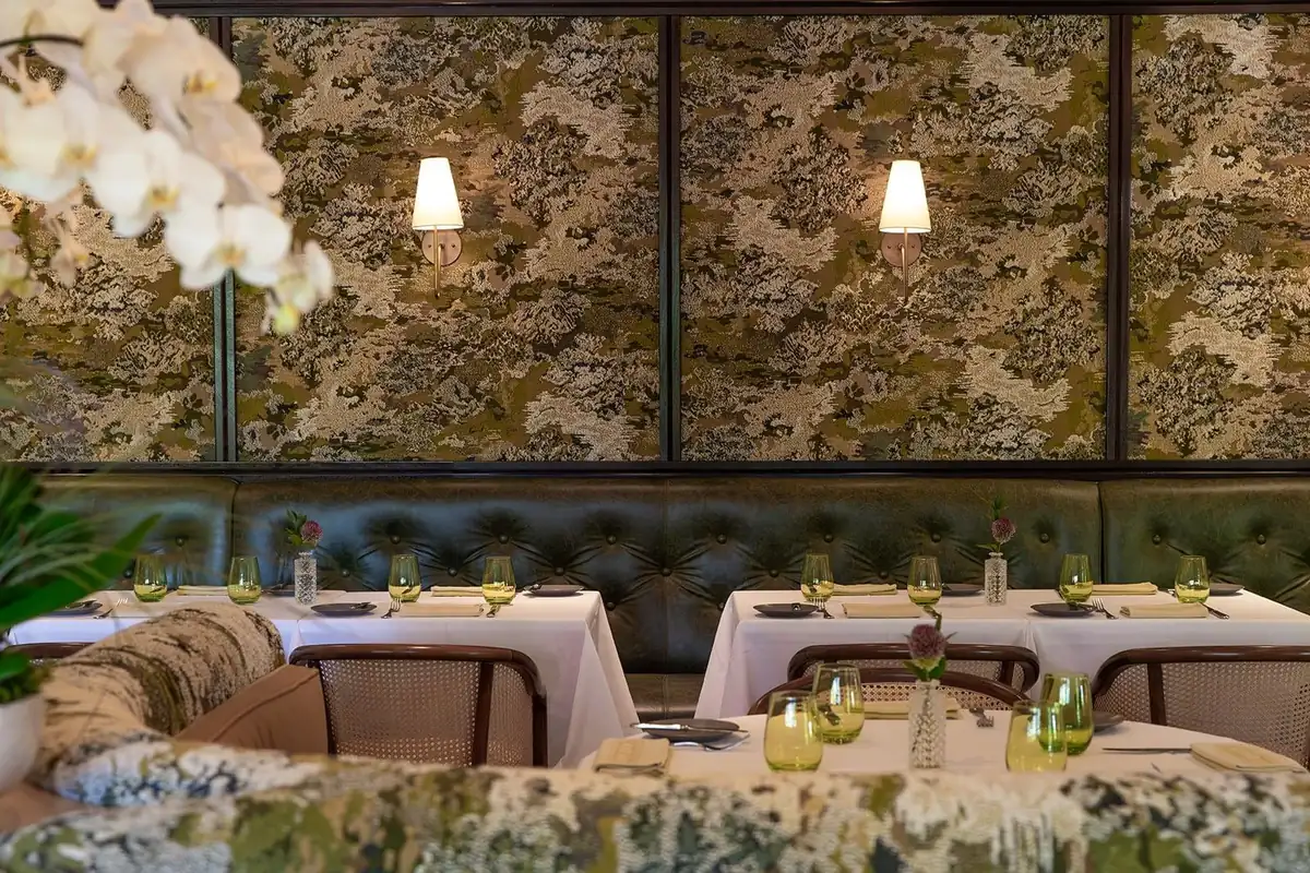 Refreshed dining room with Hermès-print banquettes at Café Boulud in The Brazilian Court, a date night restaurant in Palm Beach